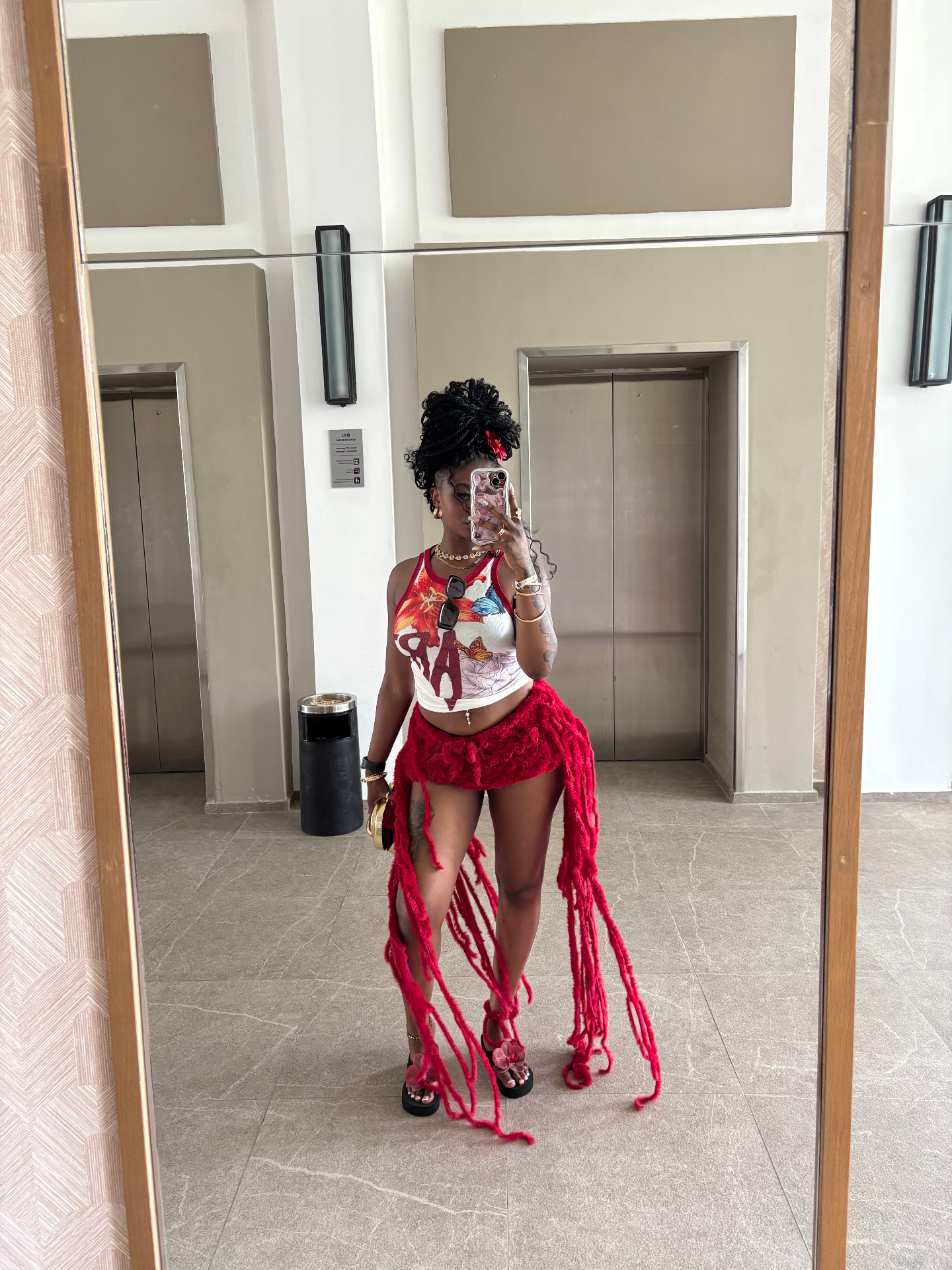 Bold red textured outfit with graphic top and statement fringe details